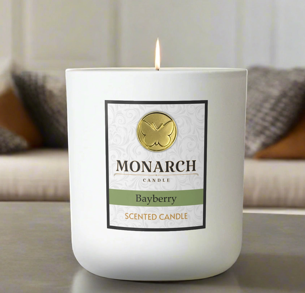 Monarch Candle labeled “Bayberry” glowing gently in a white luxury glass vessel against a warm indoor background.