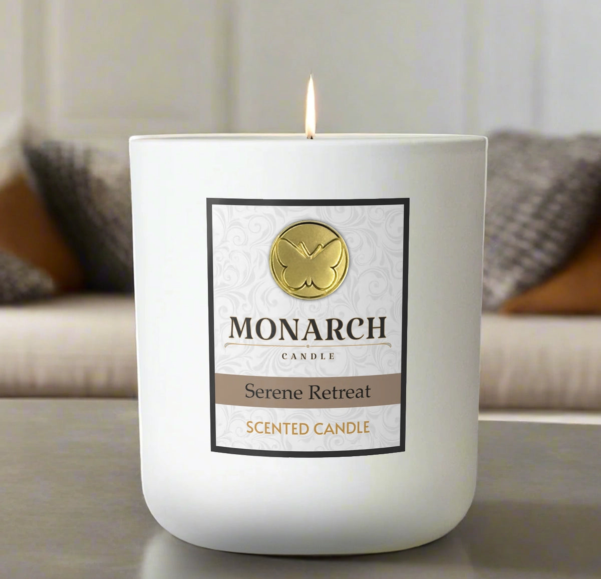 Monarch Candle labeled “Serene Retreat” glowing gently in a white luxury glass vessel against a warm indoor background.