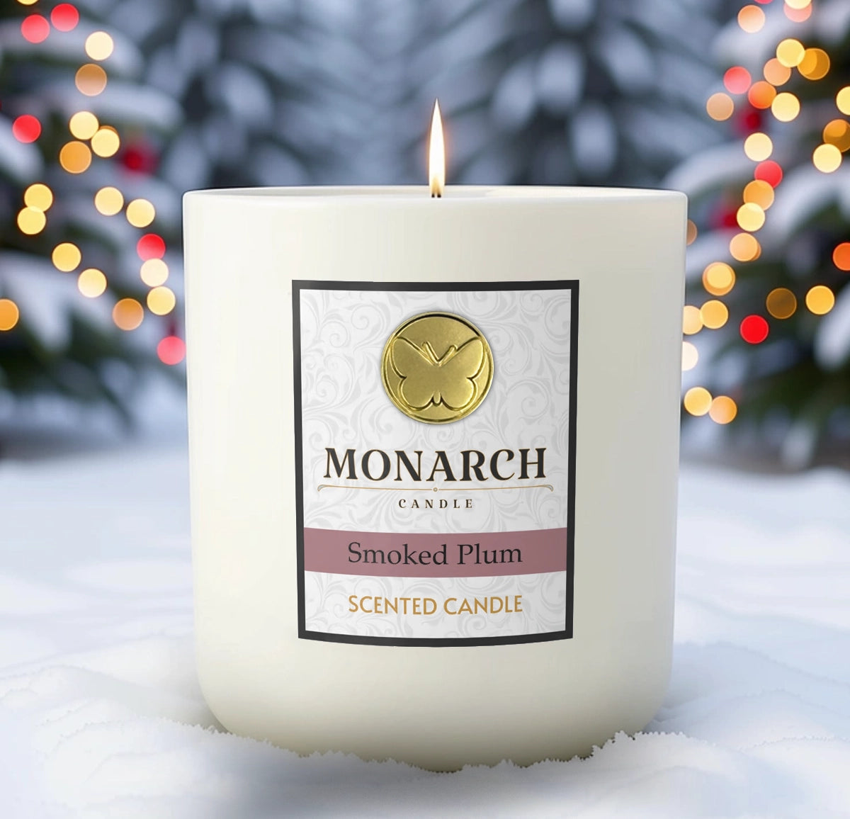 Monarch Candle labeled “Smoked Plum” glowing gently in a white luxury glass vessel against a warm festive holiday background.
