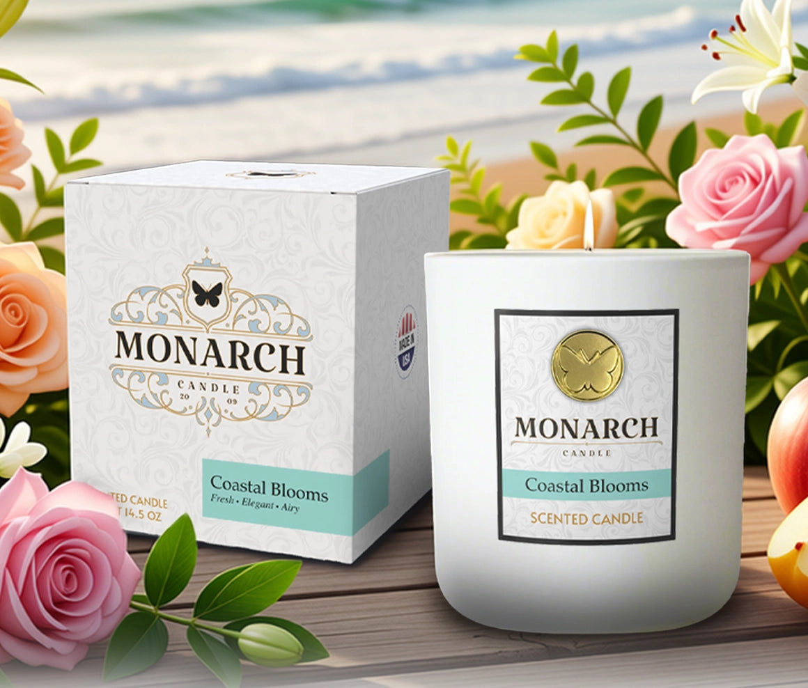 Monarch Candle "Coastal Blooms" Luxury Candle and box on a beautiful, floral coastal background with flowers, tropical fruit and the ocean in the background.