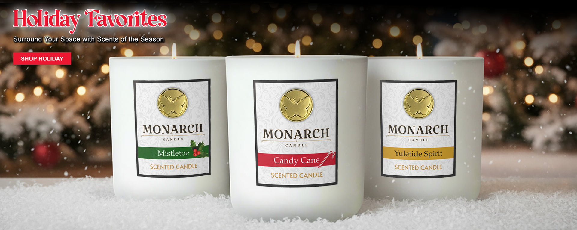 Three Monarch Candles labeled “Mistletoe,” “Candy Cane,” and “Yuletide Spirit” displayed on a snowy surface with festive holiday decorations in the background. A title reads "Holiday Favorites" and a second line of text reads "Surround Your Space wih Scents of the Season". A read "SHOP HOLIDAY" button is below the type. Black Friday offer reads: "$10 OFF Each Luxury Candle when you buy 3 or more luxury candles".