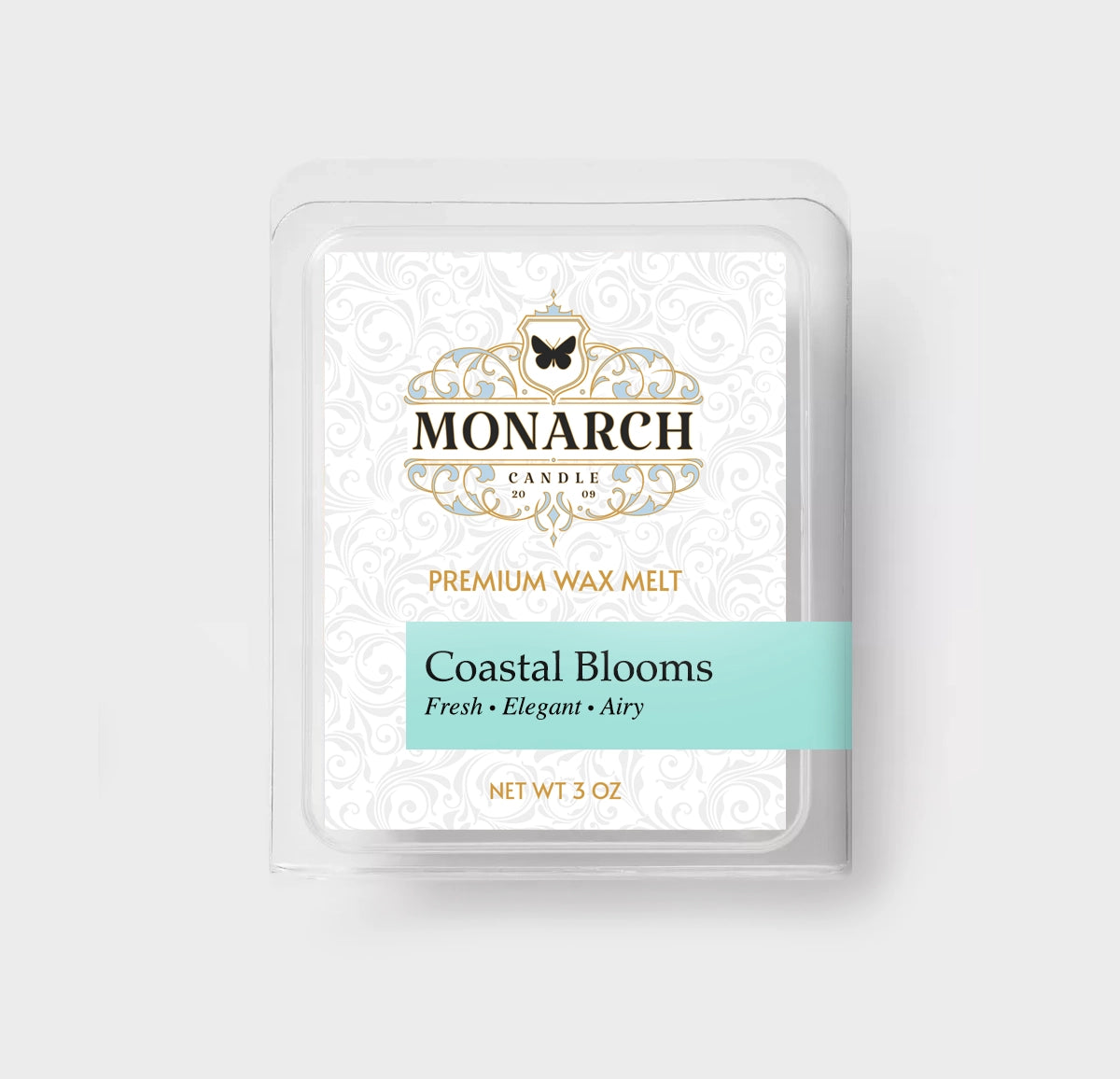 Monarch Candle premium wax melt packaging labeled “Coastal Blooms” displayed on a neutral gray background.