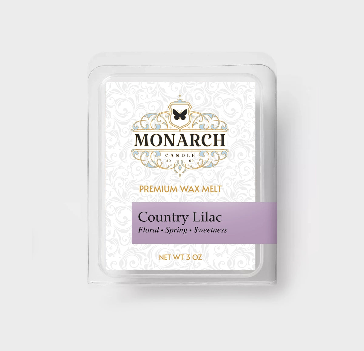 Monarch Candle premium wax melt packaging labeled “Country Lilac” displayed on a neutral gray background.