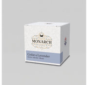 Monarch Candle votive box packaging labeled “Cedar & Lavender” displayed on a neutral gray background.