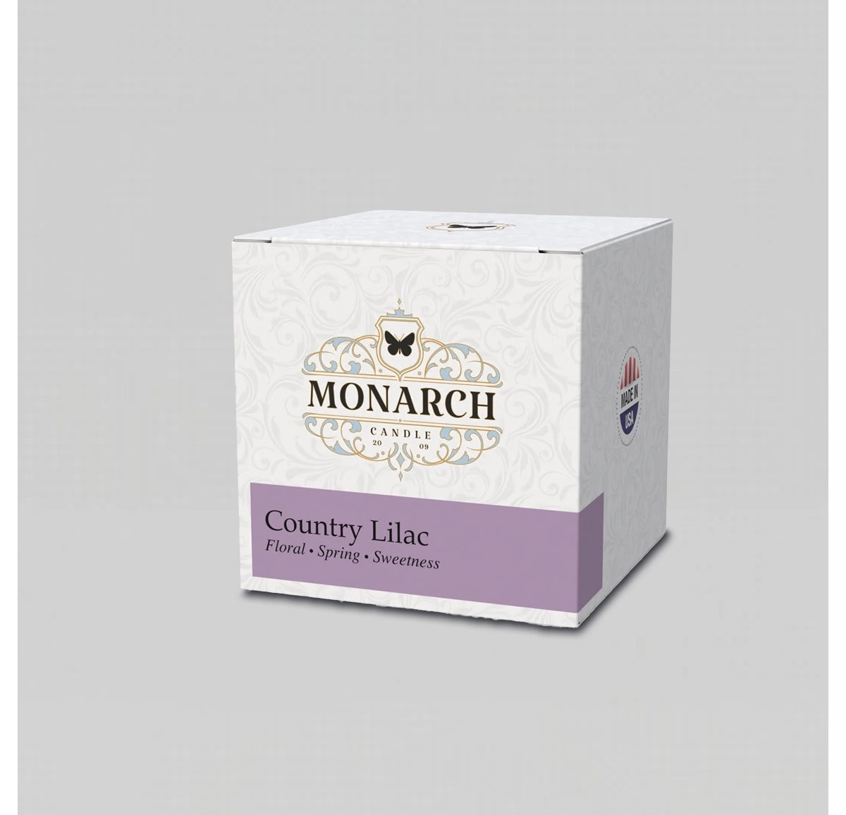 Monarch Candle votive box packaging labeled “Country Lilac” displayed on a neutral gray background.