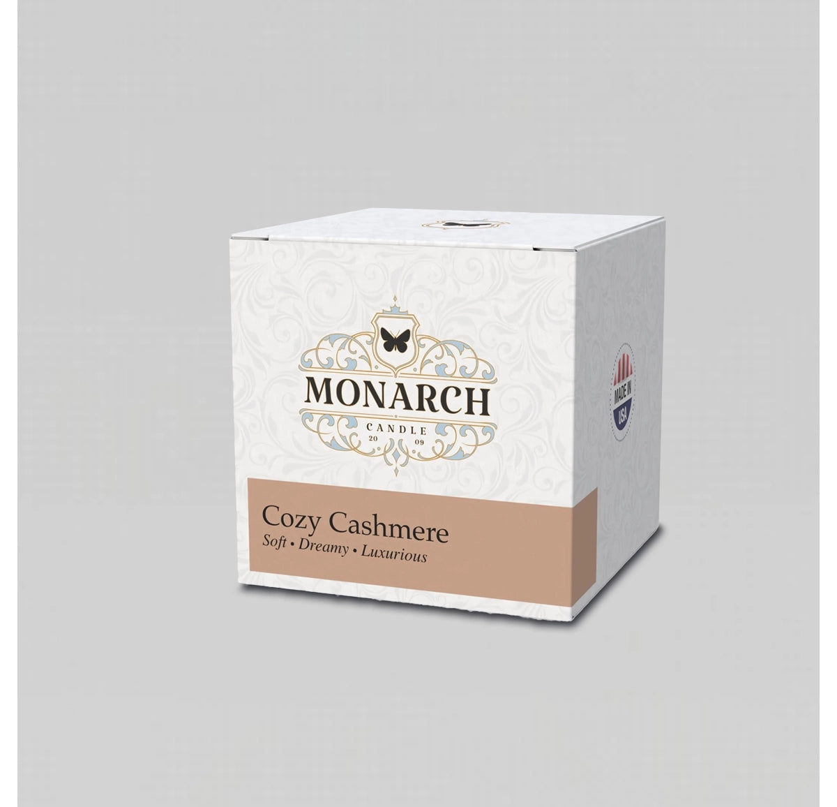 Monarch Candle votive box packaging labeled “Cozy Cashmere” displayed on a neutral gray background.