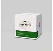 Monarch Candle votive box packaging labeled “Mistletoe” displayed on a neutral gray background.
