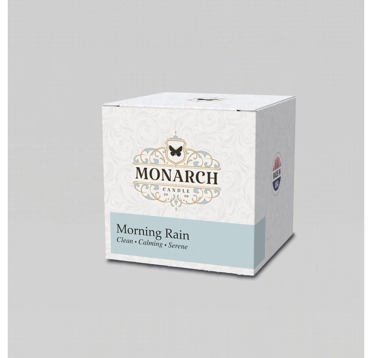Monarch Candle votive box packaging labeled “Morning Rain” displayed on a neutral gray background.