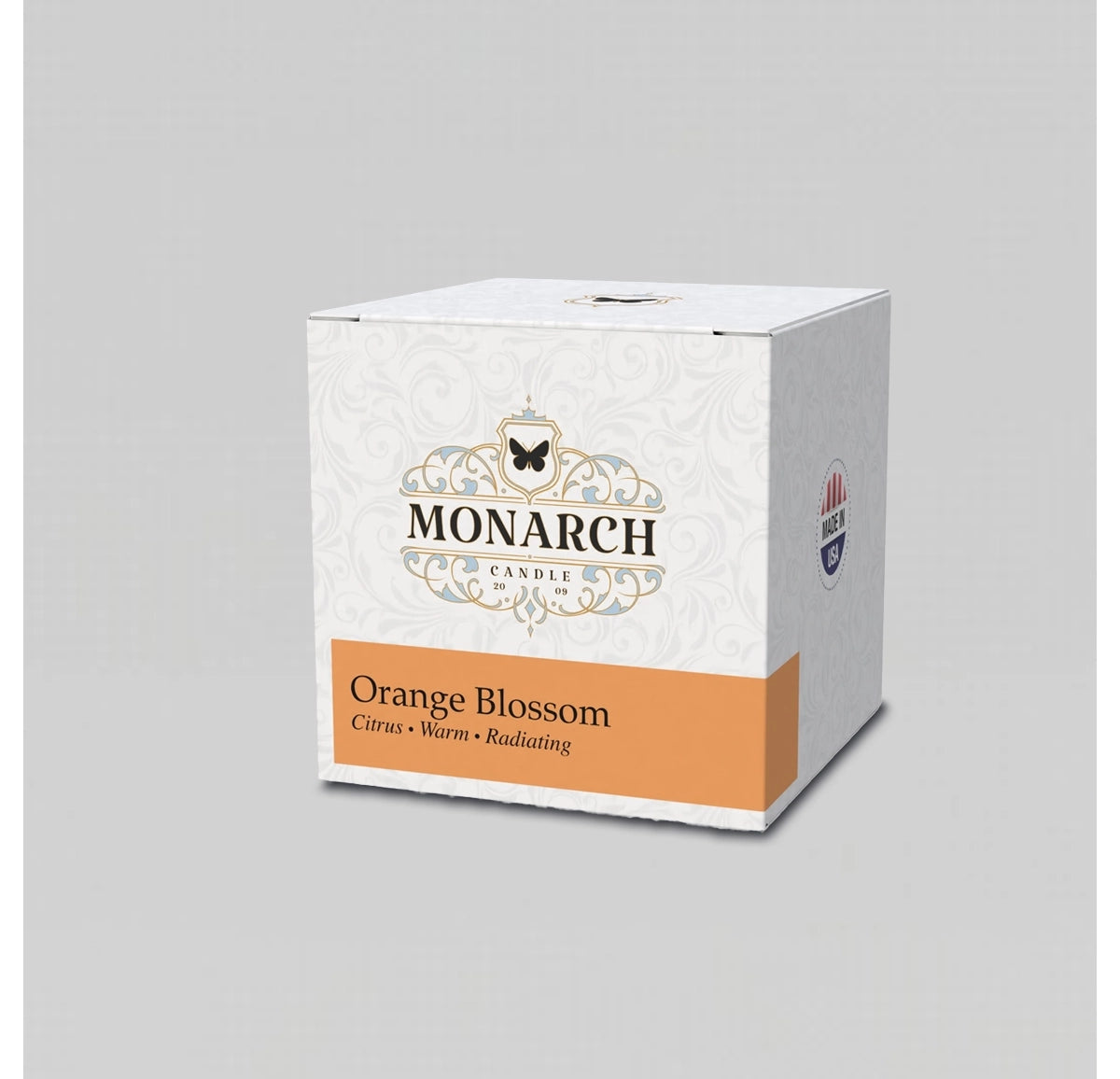 Monarch Candle votive box packaging labeled “Orange Blossom” displayed on a neutral gray background.