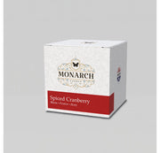 Monarch Candle votive box packaging labeled “Spiced Cranberry” displayed on a neutral gray background.