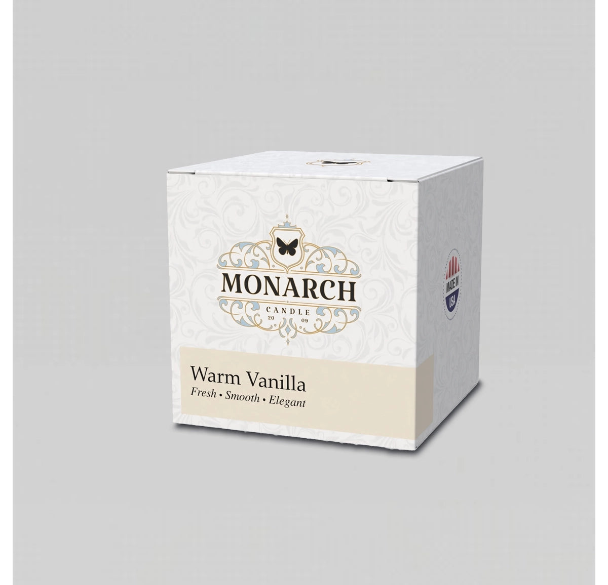 Monarch Candle votive box packaging labeled “Warm Vanilla” displayed on a neutral gray background.